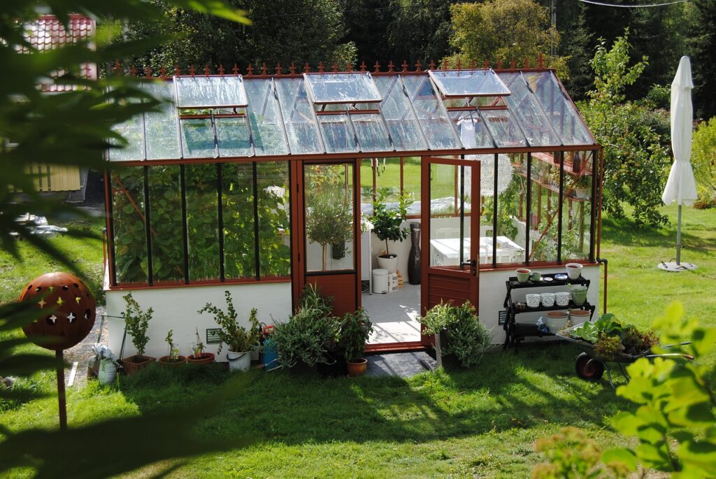 Lovely greenhouse in a back yard.
